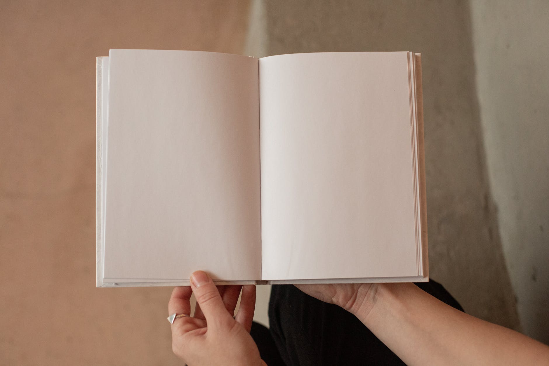 woman holding book with blank pages